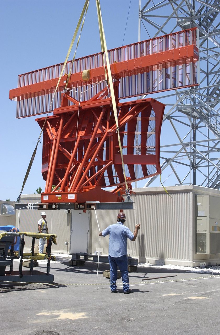 Air traffic control radar tower against a clear blue sky, with antennas and equipment visible.
