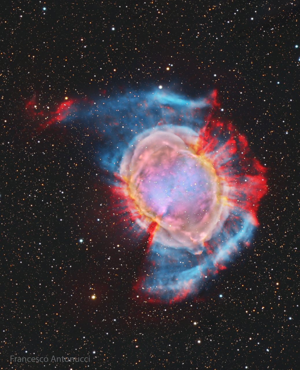 A vibrant image of M27, the Dumbbell Nebula, showcasing its distinct hourglass shape and colorful gas clouds.