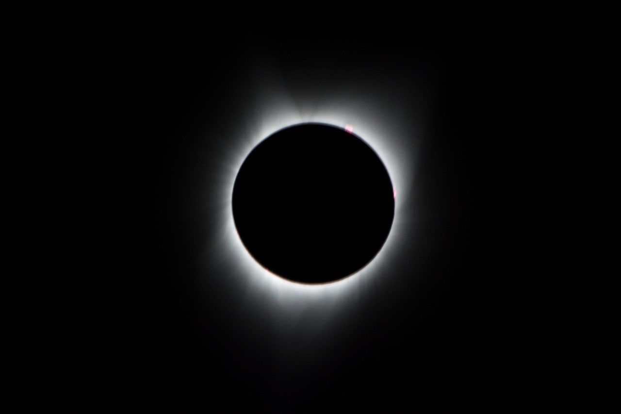 A dramatic image of the 2017 total solar eclipse with a darkened sky.