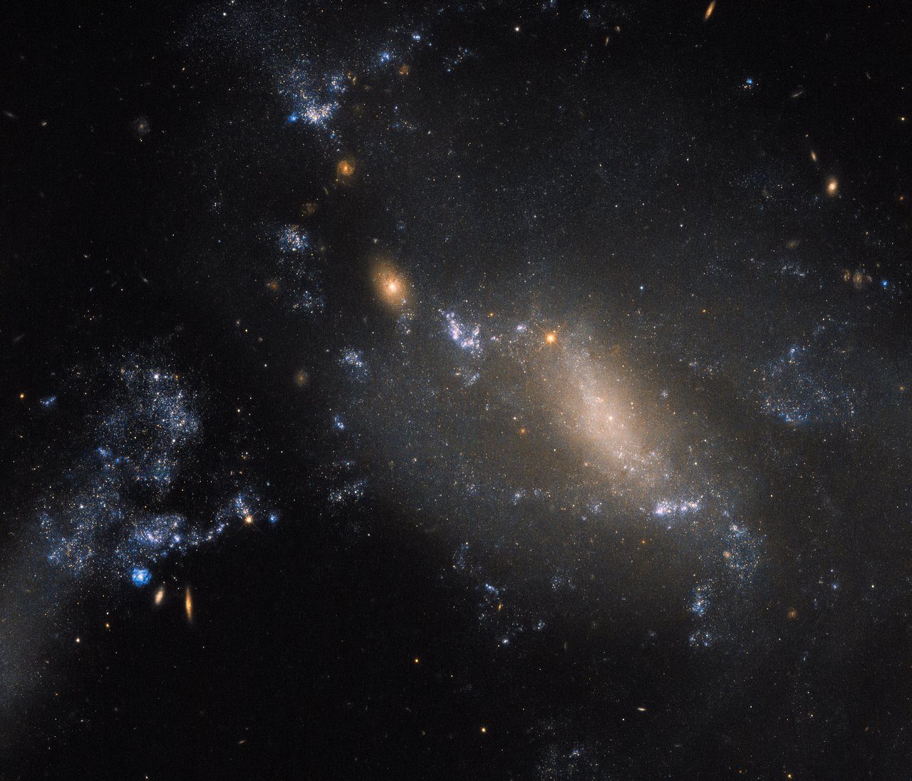 Hubble captures NGC 3447, two interacting galaxies creating a cosmic dance with swirling star formations.