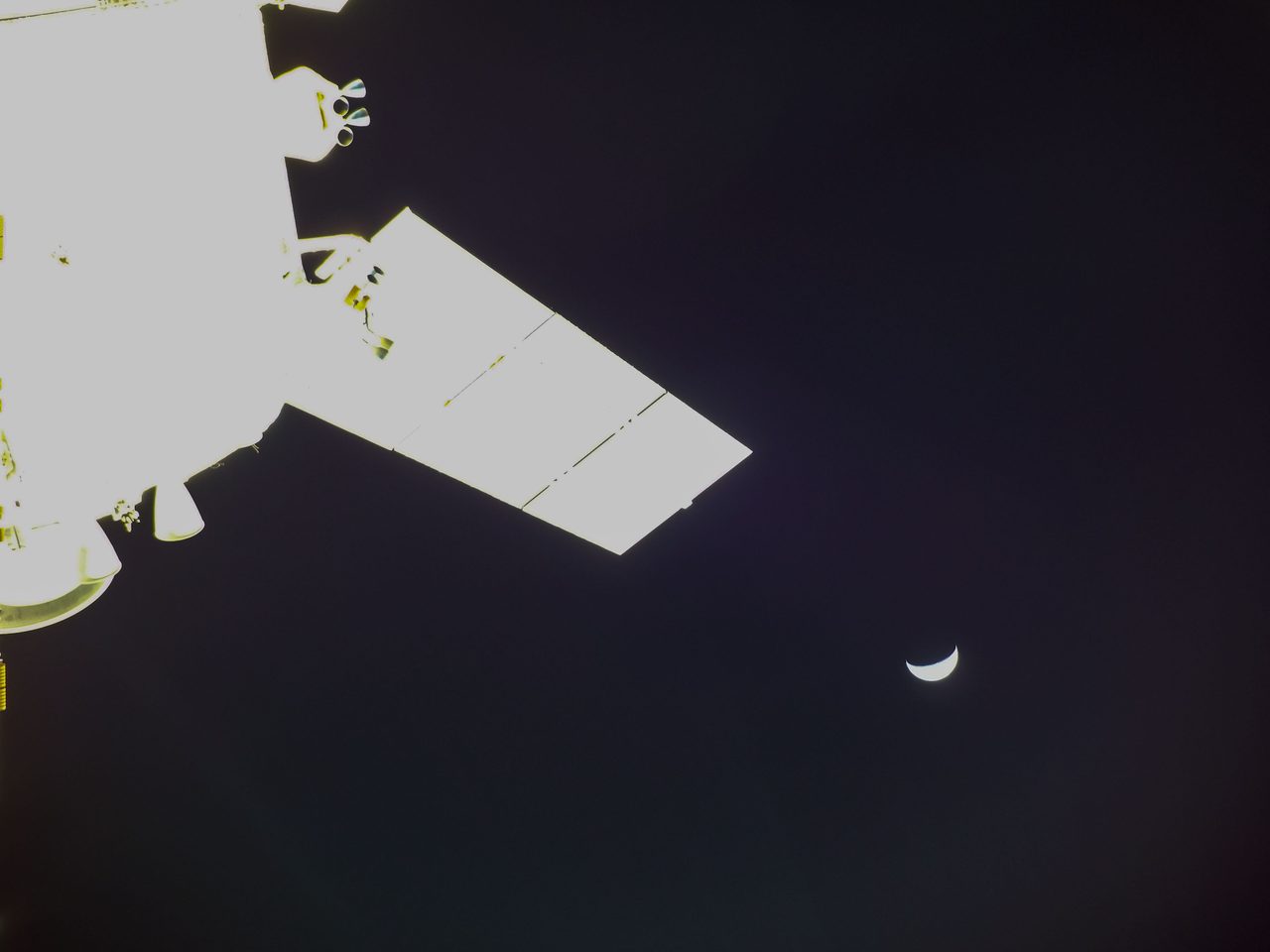 Artemis I Flight Day 17 with Orion spacecraft and crescent moon, highlighting modern space exploration.