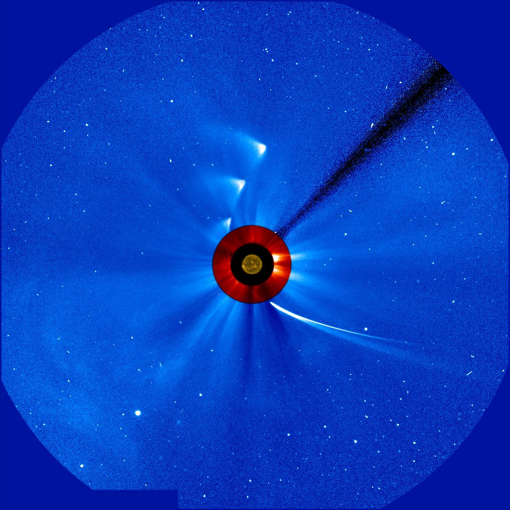 A bright, glowing Comet ISON streaks across the night sky with a long, luminous tail.