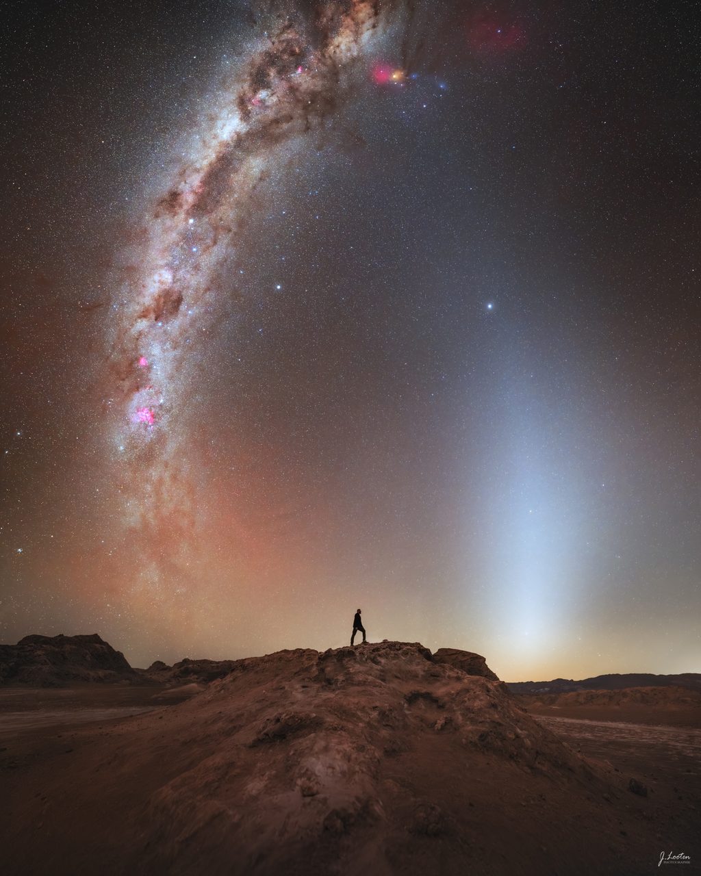 Colorful aurora-like bands illuminate the night sky over the Atacama Desert, creating a stunning celestial display.