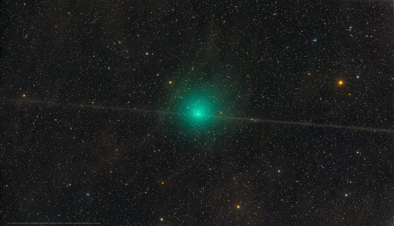 A long dust trail streaming from Comet Tempel 2 against a starry night sky, showcasing its celestial path.