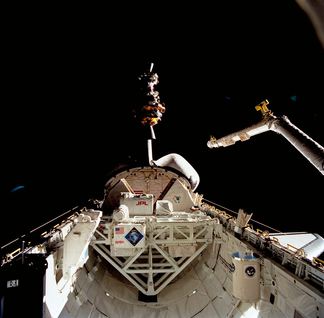 LAGEOS and IRIS spacecraft being deployed from Space Shuttle Columbia's payload bay during STS-52 mission.