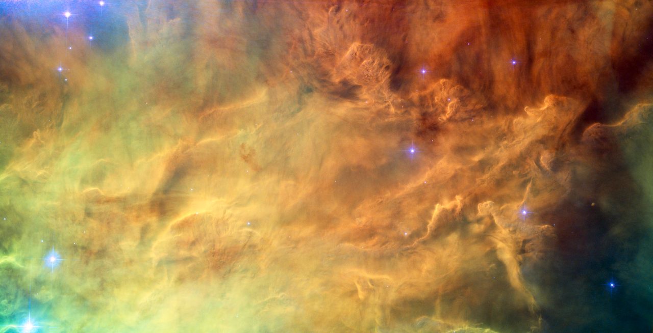 Hubble image showing vibrant colors and intricate details of the Lagoon Nebula's core.