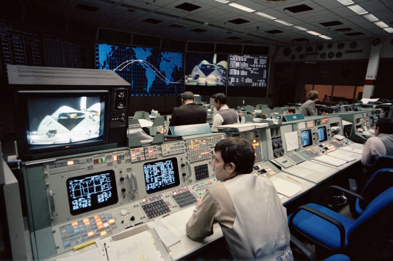 Mission Control Center staff monitoring STS-11/41B space mission operations.