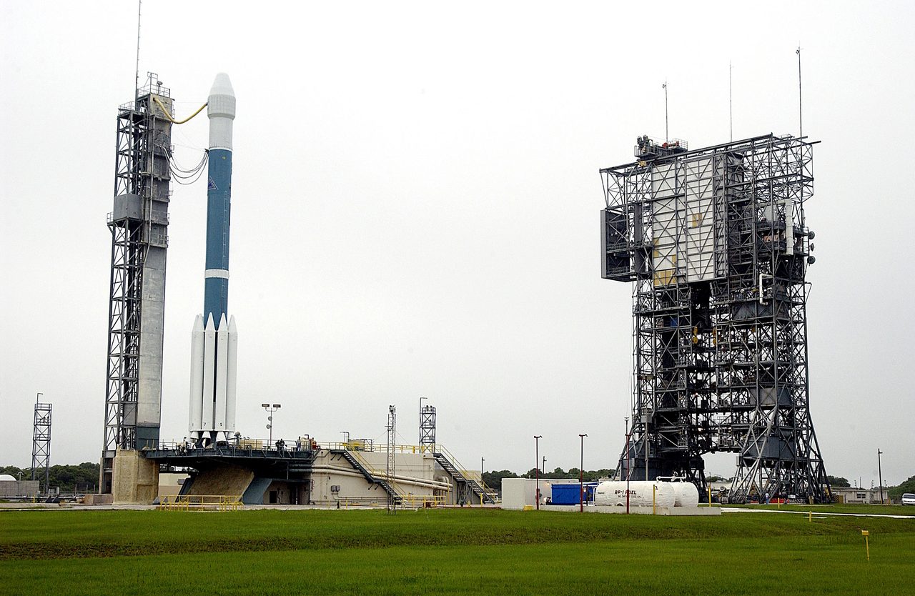 Boeing Delta II rocket with Mars Rover MER-A ready for launch at Cape Canaveral, clear sky background.