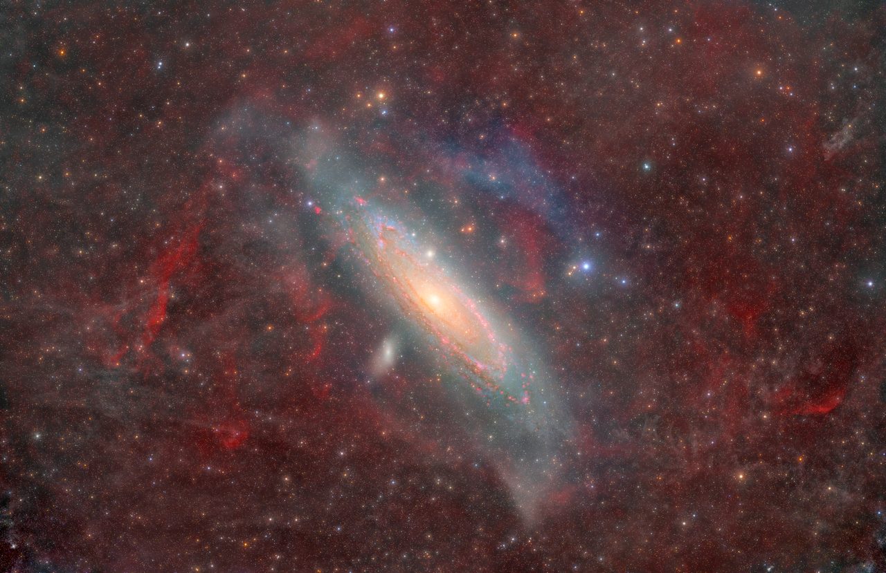 A stunning view of the Andromeda Galaxy, partially obscured by swirling interstellar gas and dust clouds.