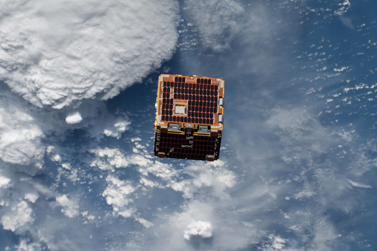 A satellite being launched into space, showcasing the RemoveDEBRIS mission to tackle space debris.