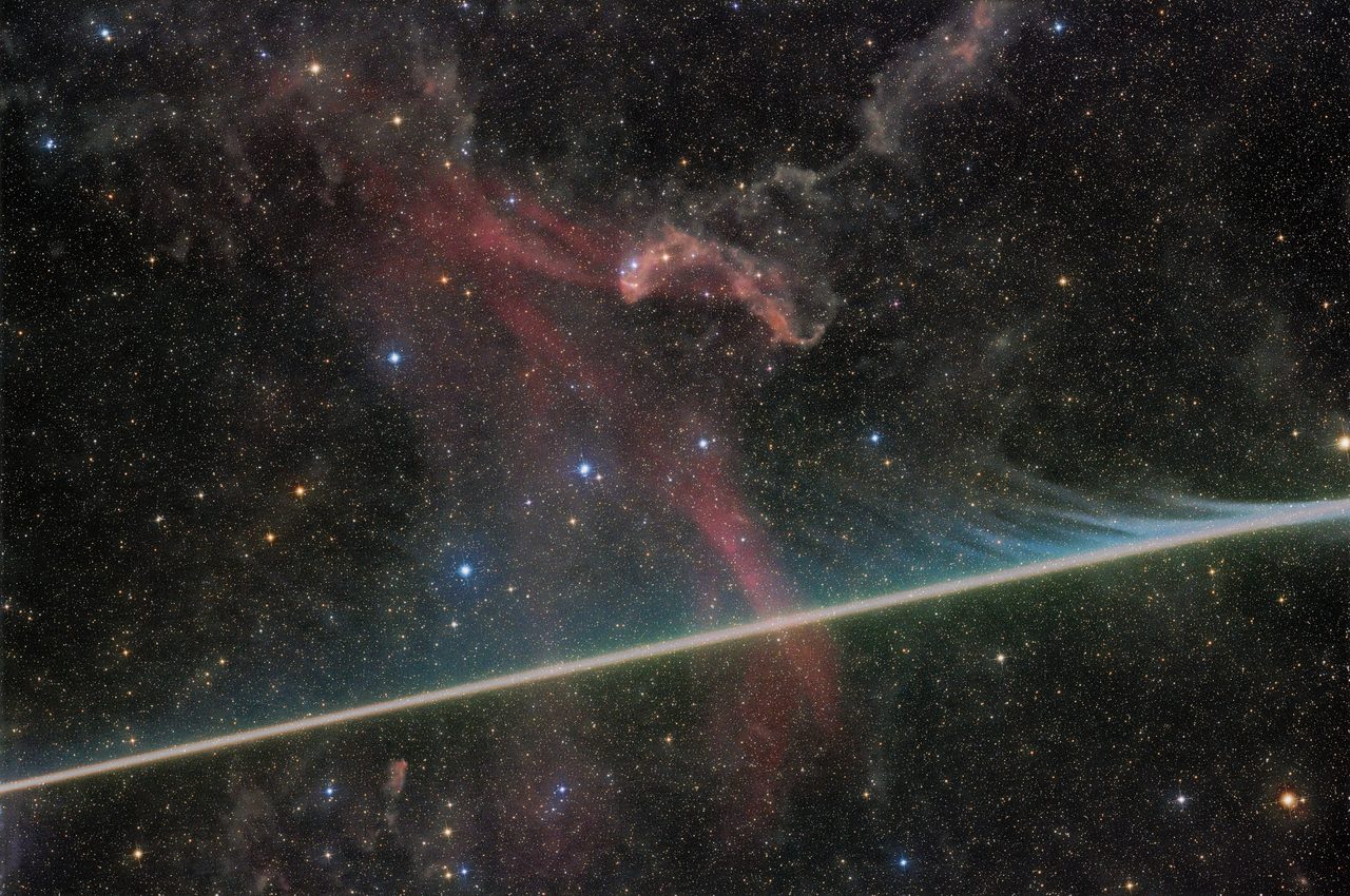 A bright meteor streaks across the night sky, illuminating the Lacerta Nebula with vibrant colors.