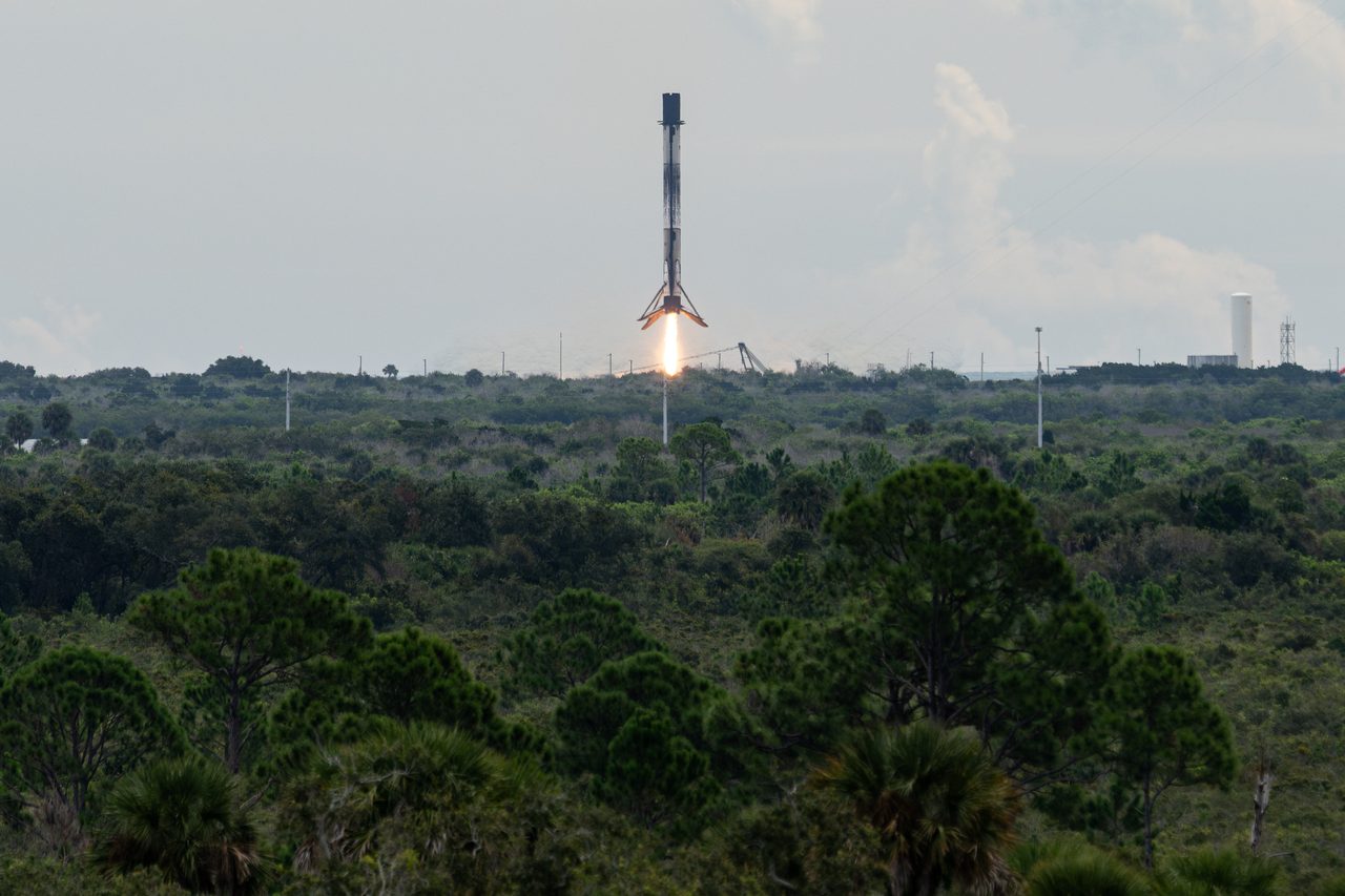 SpaceX Falcon 9 rocket landing vertically after successful NASA Crew-13 mission launch
