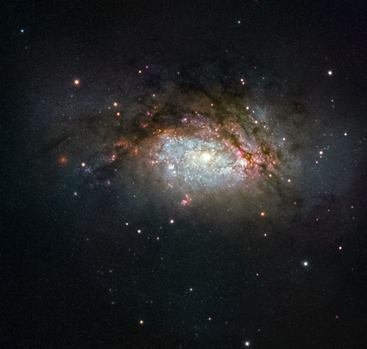 Dramatic image of two galaxies merging, showcasing swirling stars and cosmic dust.