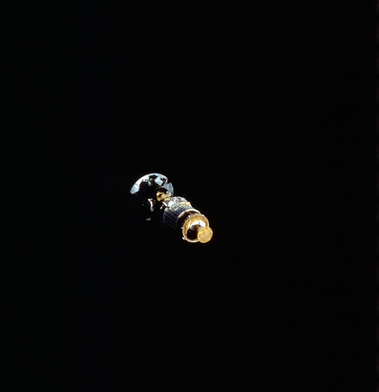 Galileo spacecraft and IUS being deployed in space during STS-34 mission, showcasing intricate engineering.