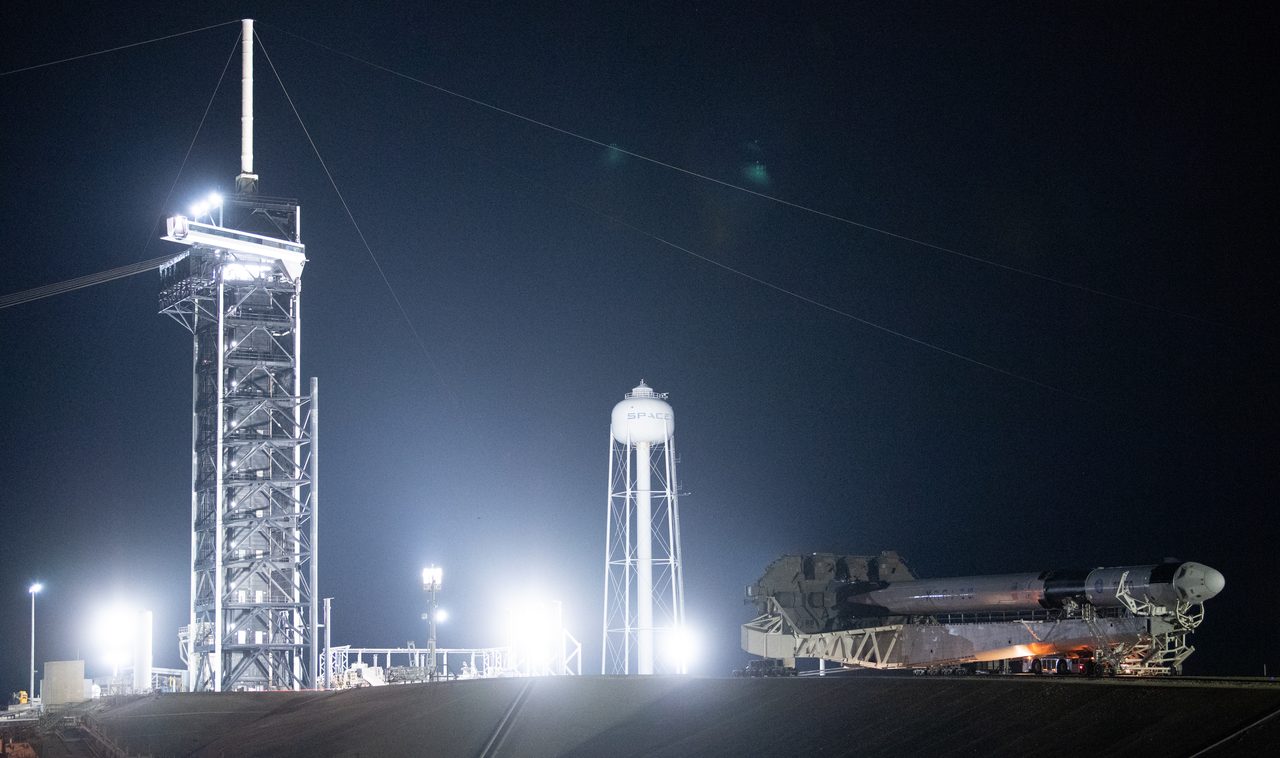 NASA's SpaceX Crew-5 Falcon 9 rocket and Dragon spacecraft on launch pad under clear blue sky.