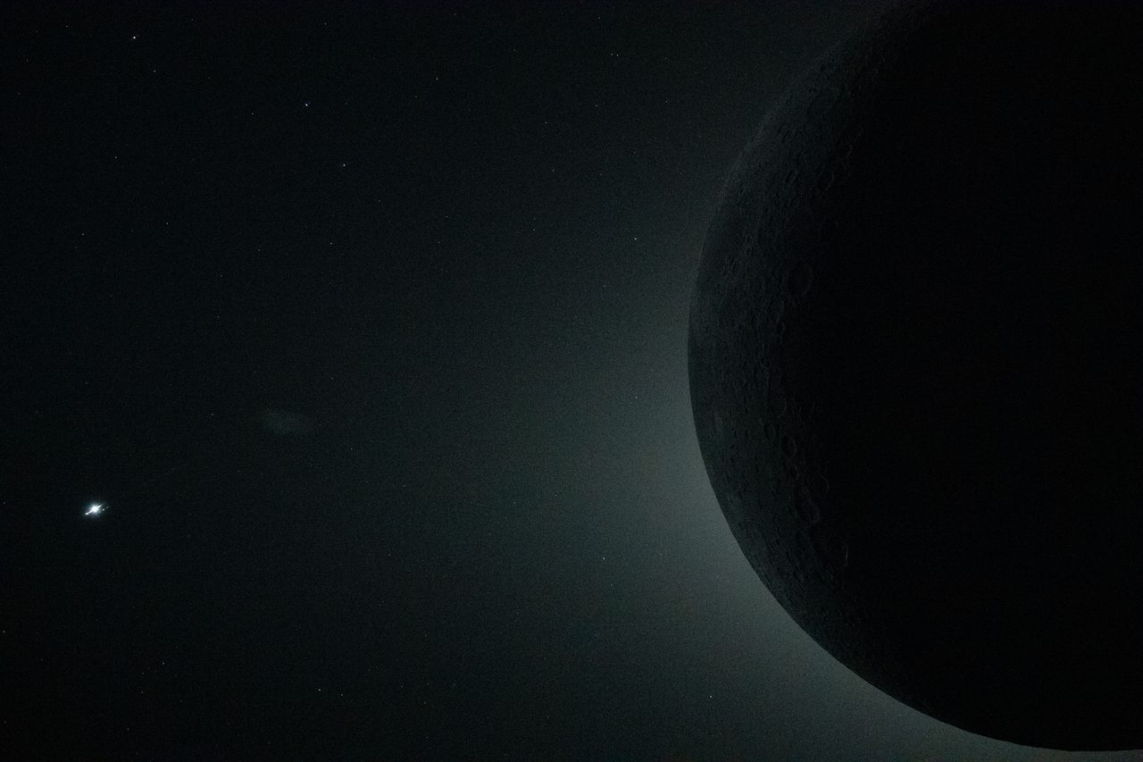 Partial frame of the Artemis II total solar eclipse, capturing the sun's corona against a darkened sky.