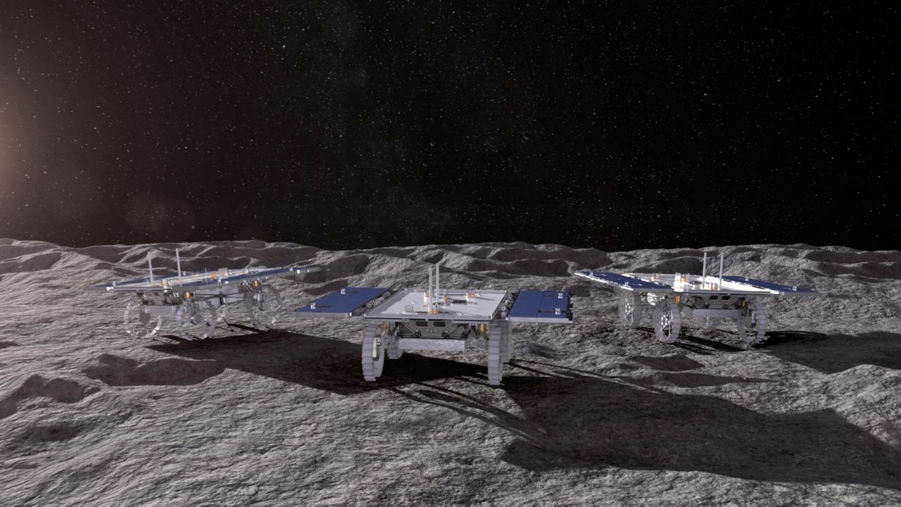 Three small rovers traverse the lunar surface in NASA's CADRE technology demonstration artist's concept.