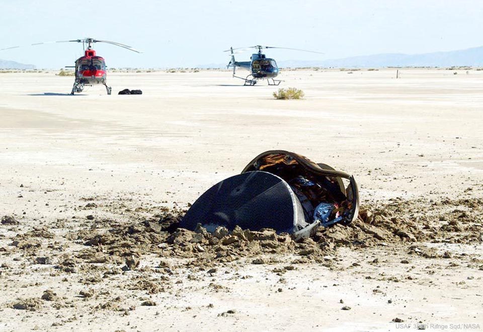 Aerial view of a flying saucer crash site in the Utah desert with scattered debris.