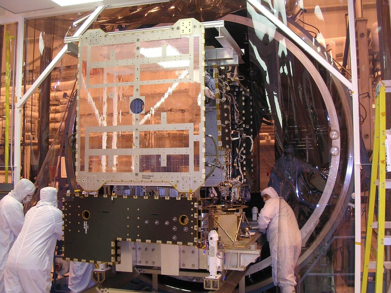 NASA's Dawn spacecraft being carefully positioned into a thermal vacuum chamber for testing.
