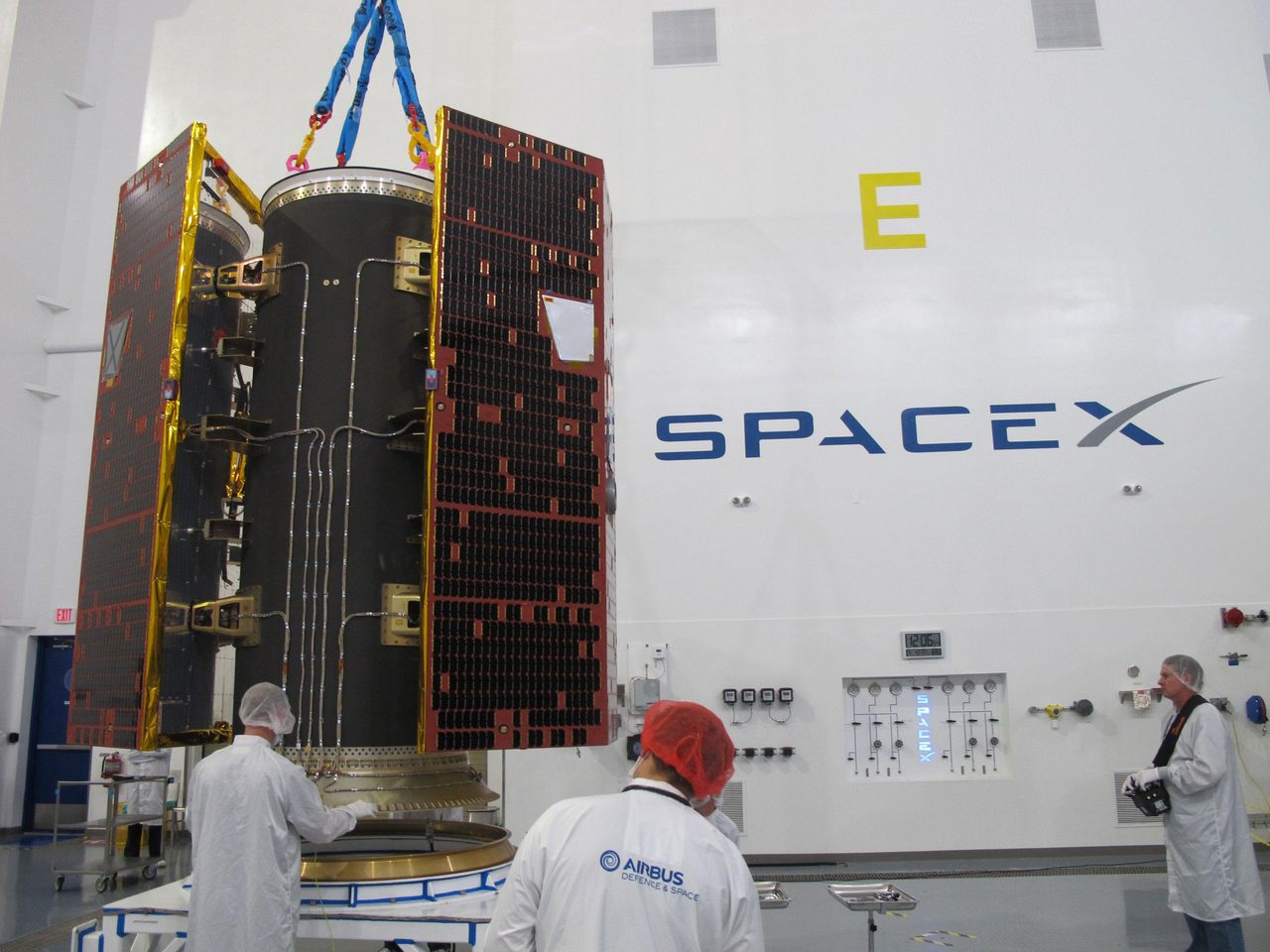 Technicians examine NASA's twin GRACE Follow-On satellites and dispenser at SpaceX, Vandenberg Air Force Base, California.