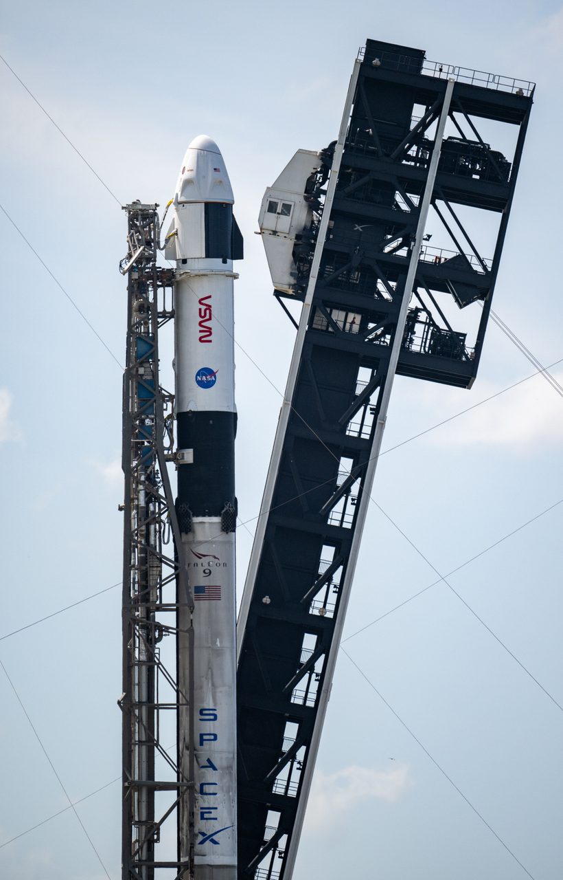 NASA’s SpaceX Crew-9 Falcon 9 and Dragon spacecraft being rolled out at Space Launch Complex under clear skies.