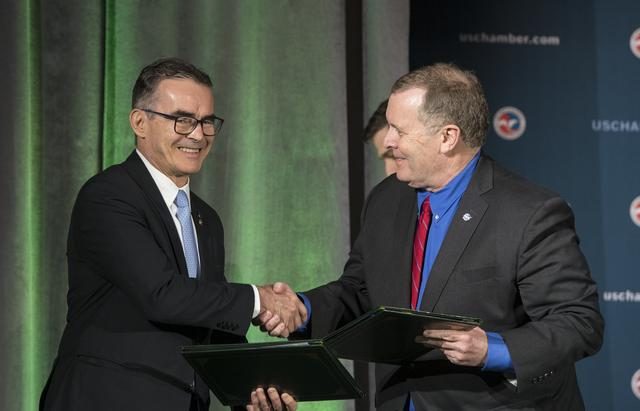 NASA Deputy Administrator signing agreement with Brazilian officials for SPORT collaboration, seated at conference table.