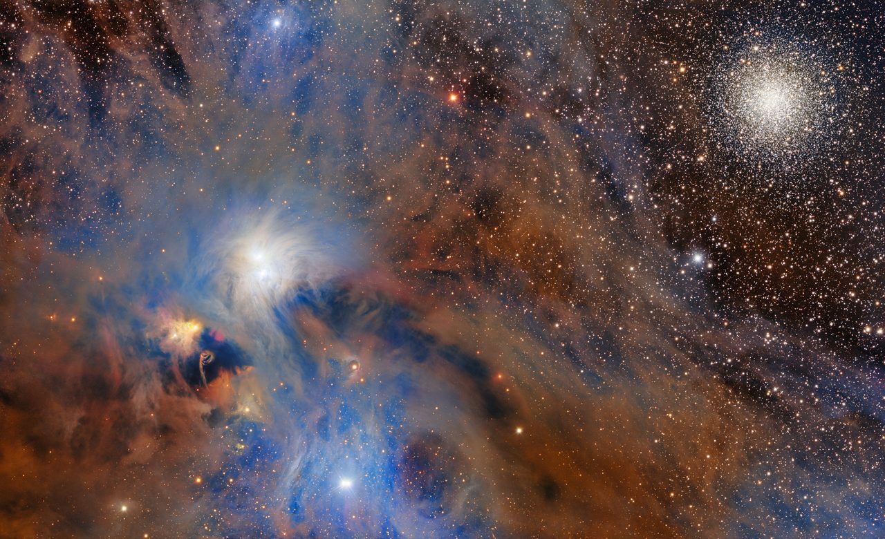 A dense, dark molecular cloud with bright stars of the Chandelier Cluster shining through.