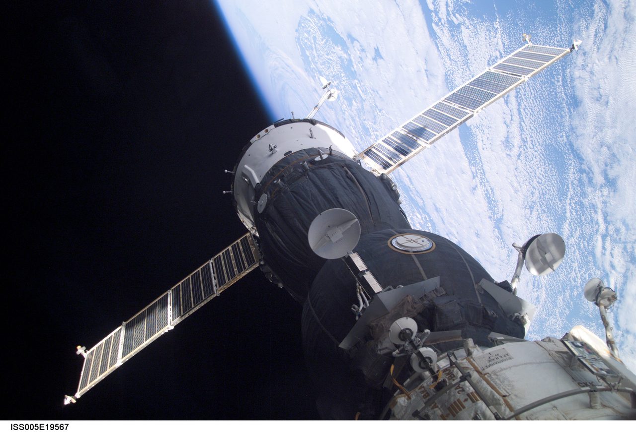 Soyuz spacecraft securely docked at Pirs Docking Compartment on International Space Station during Expedition Five.