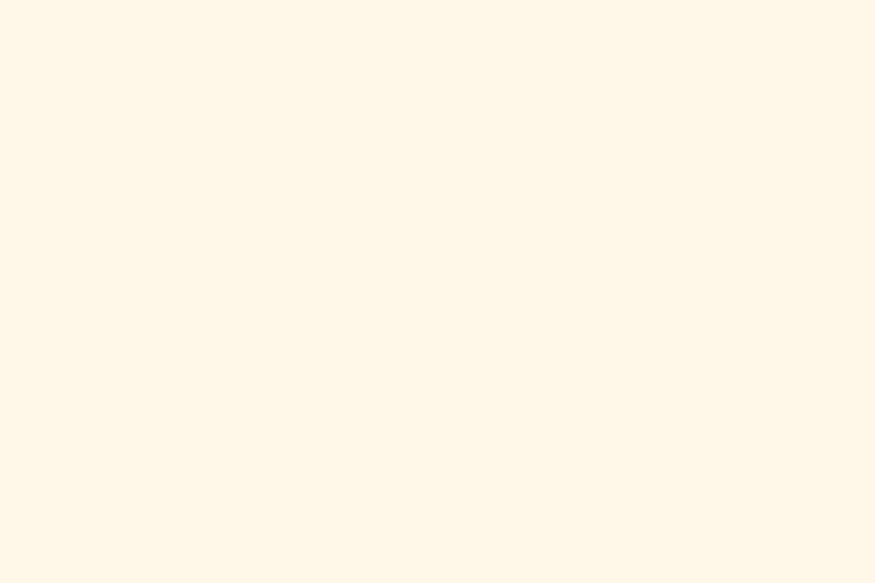 A swirling galaxy with stars, showcasing the soft beige hue known as Cosmic Latte, the universe's average color.