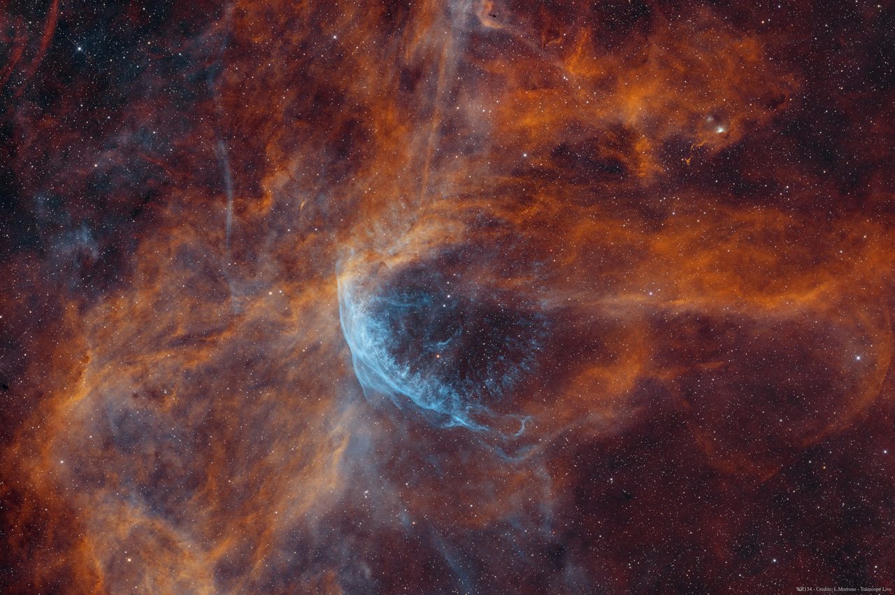 A vibrant, swirling nebula with bright stars surrounding the Wolf-Rayet star WR 134 in deep space.