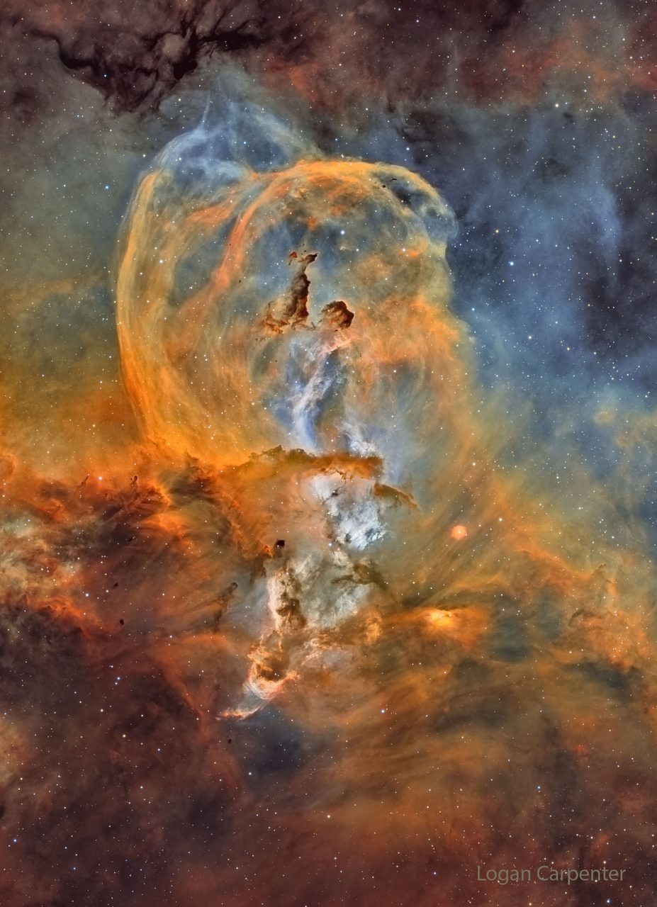 A vibrant cosmic cloud resembling the Statue of Liberty, with bright stars and colorful gas formations.