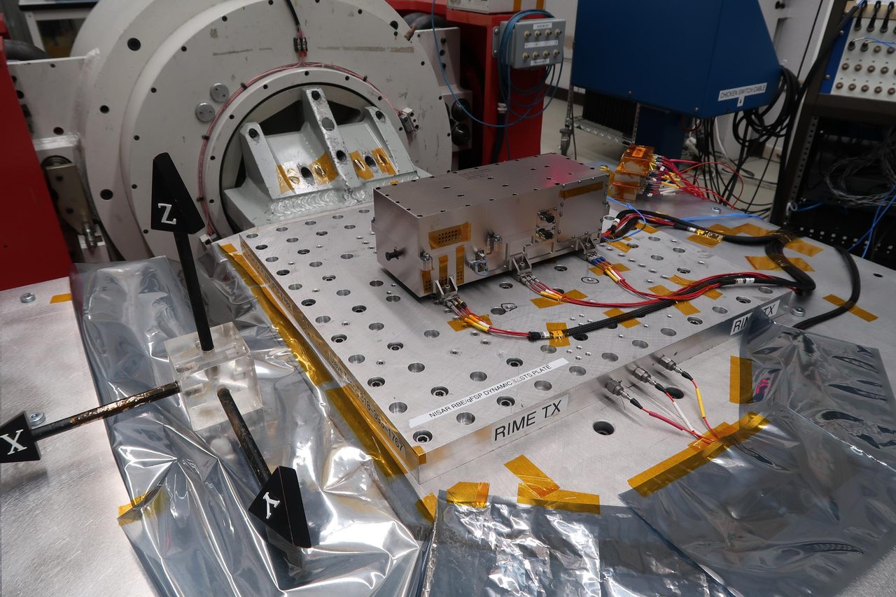 Technicians conduct vibration testing on JUICE mission's RIME radar transmitter at NASA's Jet Propulsion Laboratory.