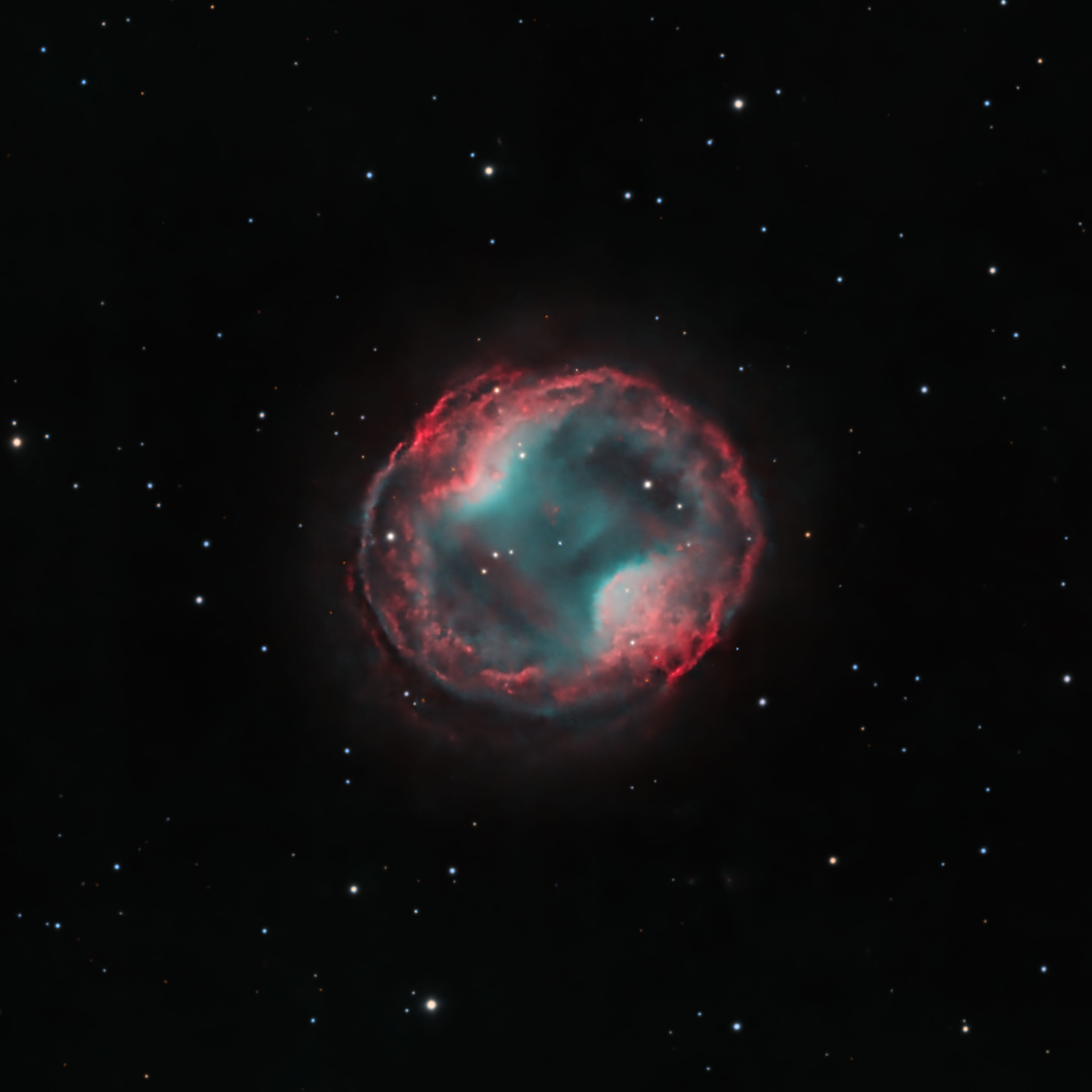 A vibrant nebula resembling headphones, with swirling colors of blue, orange, and red against a starry black background.