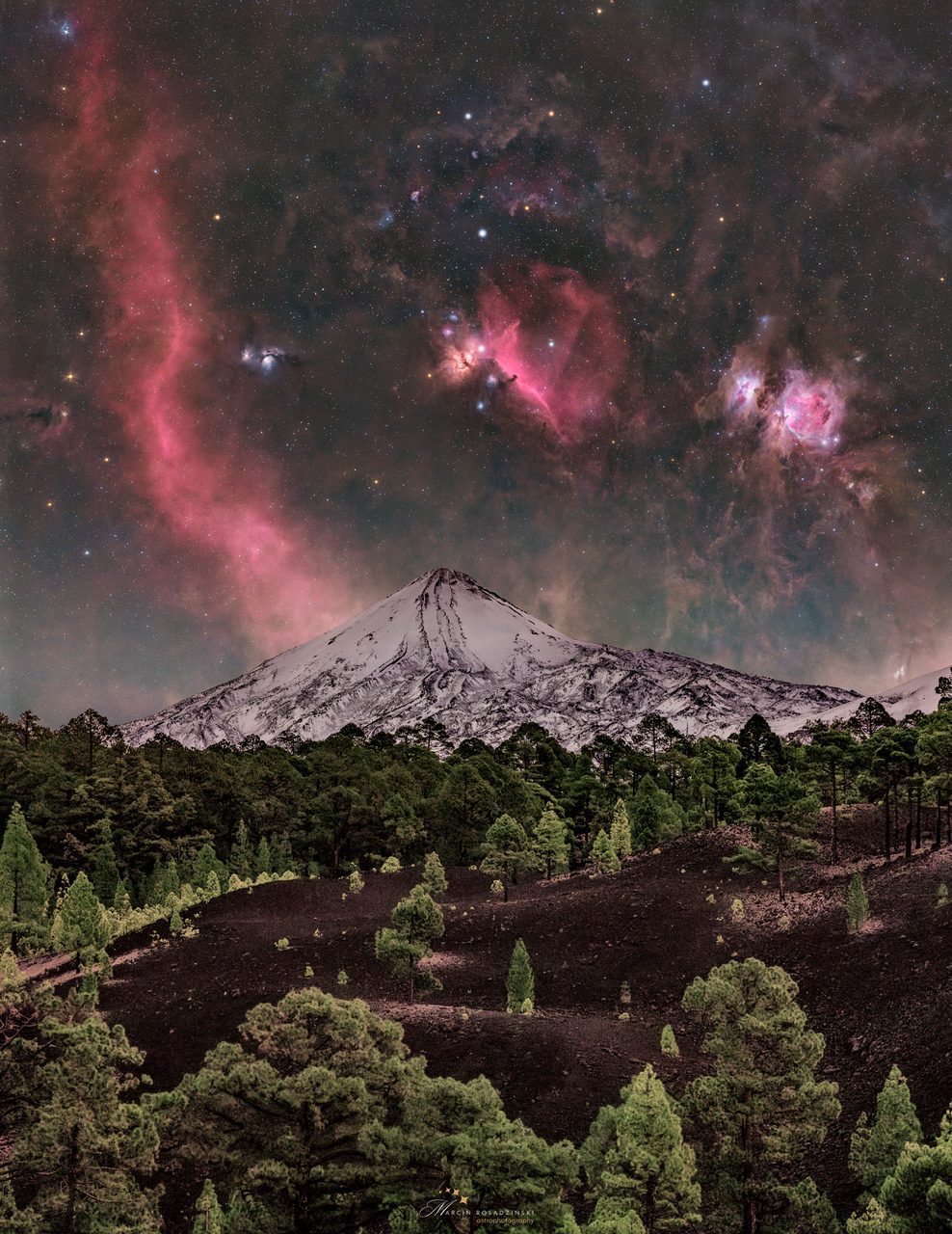 Starry night sky with Orion constellation shining brightly above snow-capped Mount Teide peak.