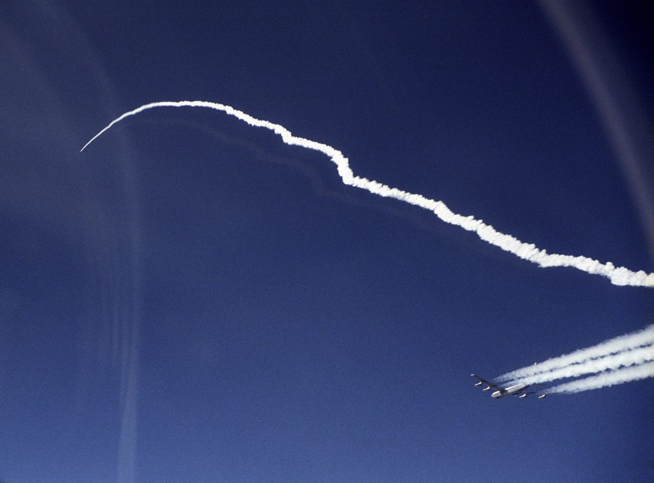 X-43A aircraft and Pegasus rocket accelerating post-launch from NASA's B-52B over Pacific Ocean.