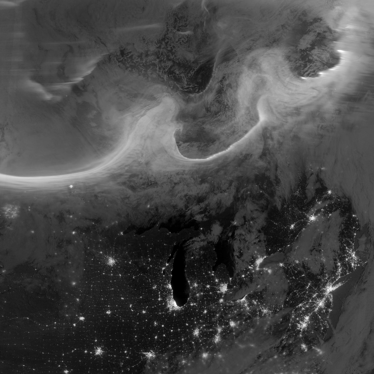 Colorful auroras illuminating the night sky over North America, captured from space.