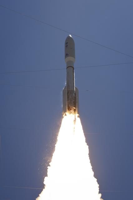 Atlas V rocket ascending into the sky, leaving a trail of smoke, carrying the Juno spacecraft.