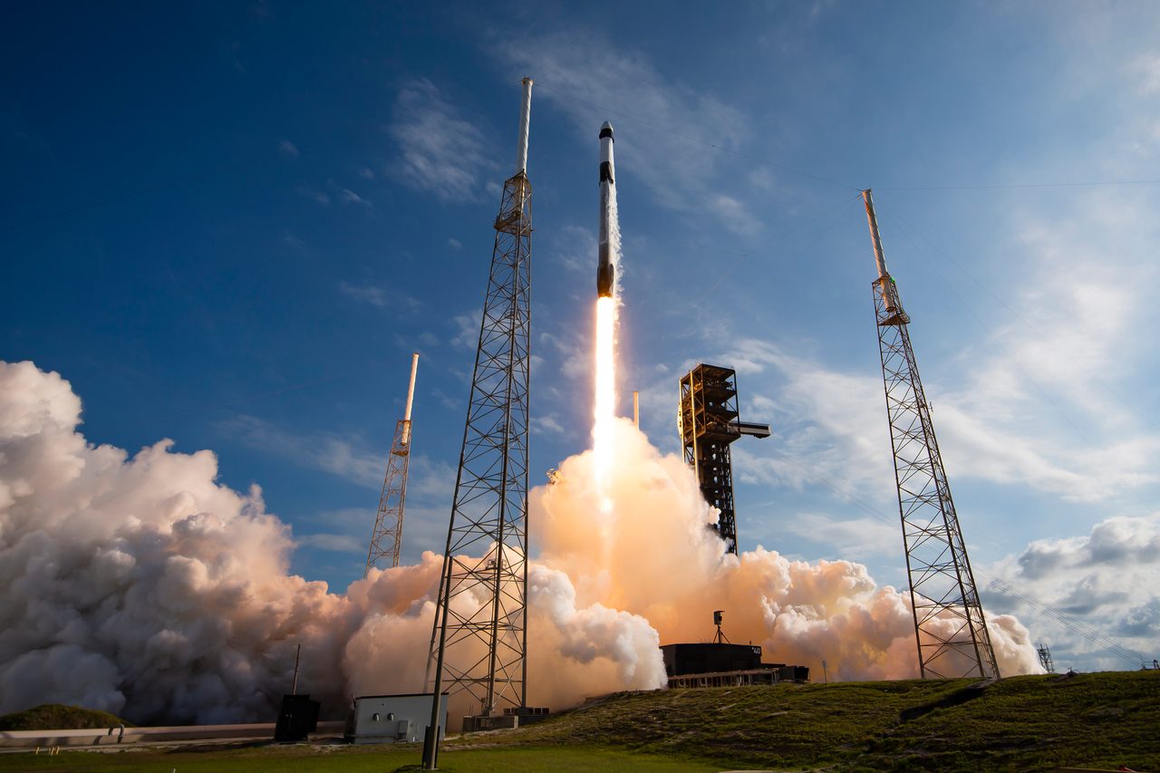 SpaceX Falcon 9 rocket launching from NASA's Kennedy Space Center, illuminating the night sky.