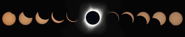 A total solar eclipse with the sun completely obscured by the moon, creating a glowing corona effect.
