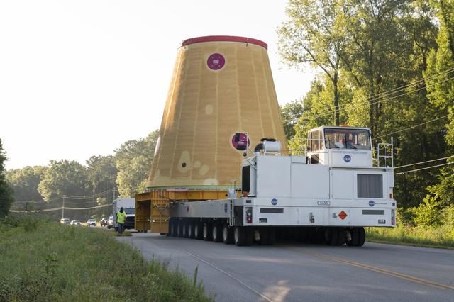 Launch Vehicle Stage Adapter being carefully loaded onto NASA Barge Pegasus for transportation.