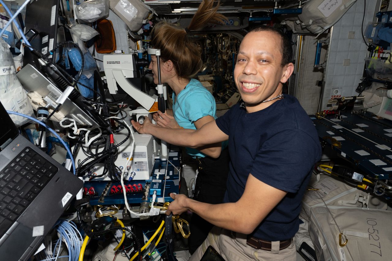 NASA astronaut Chris Williams guides ESA astronaut Sophie Adenot during an eye exam