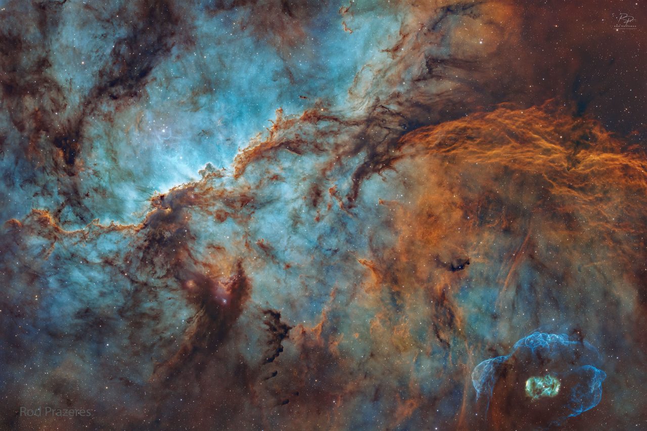 A vivid cosmic landscape featuring the NGC 6188 nebula, resembling dragons, with bright stars scattered across the dark sky.