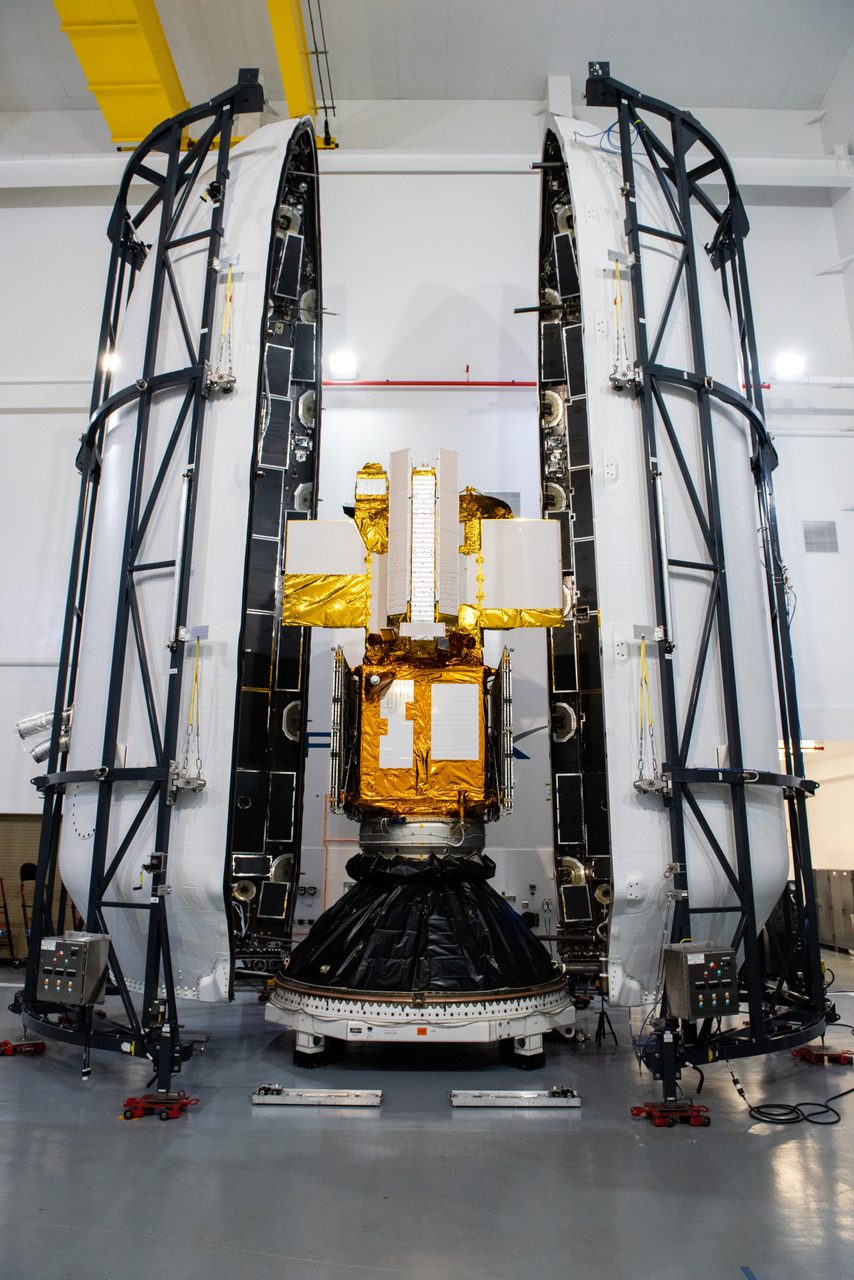 SWOT satellite inside its payload fairing, ready for launch on a SpaceX Falcon 9 rocket.