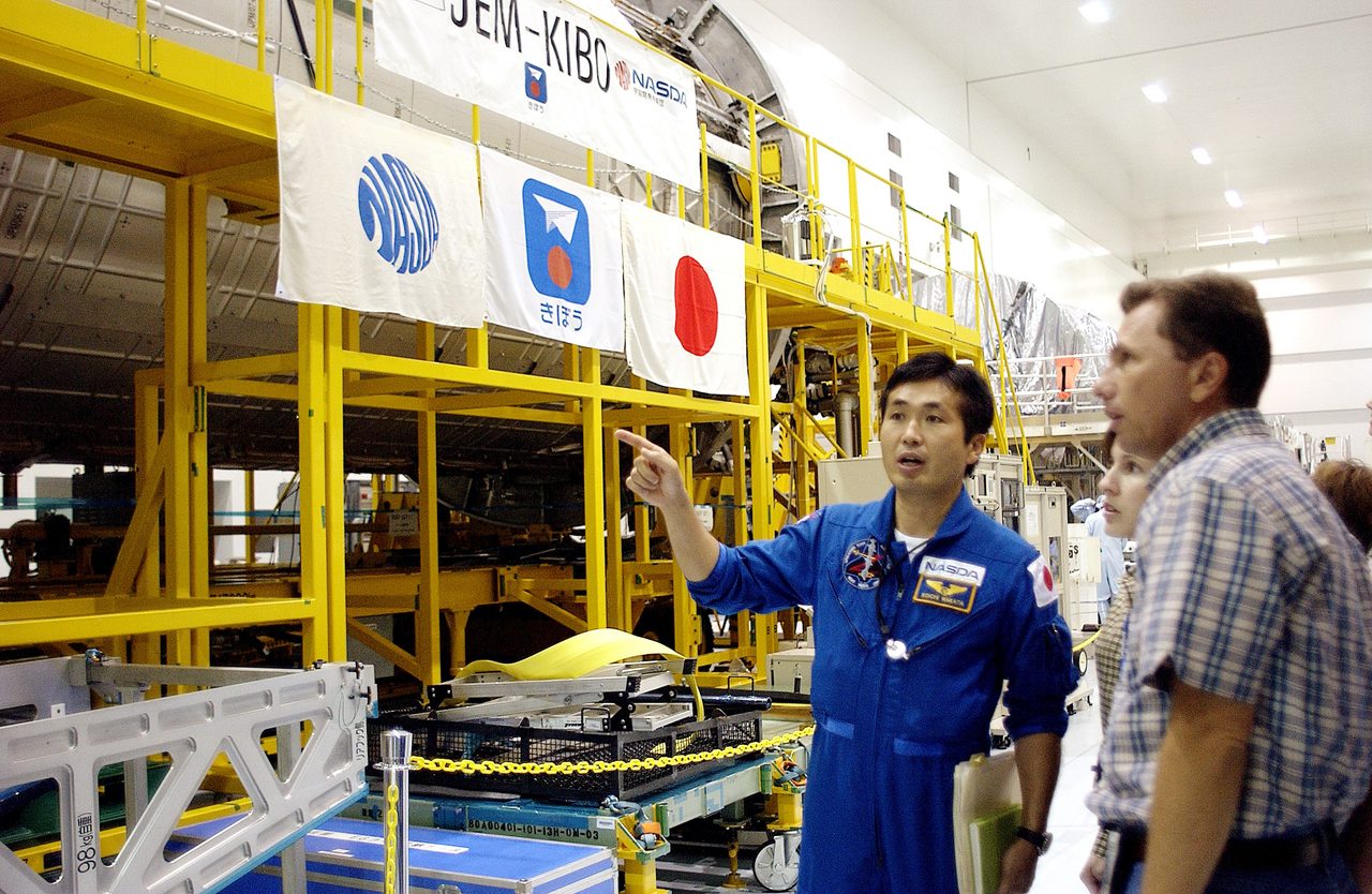 Japanese astronaut Koichi Wakata examines the Pressurized Module in the Space Station Processing Facility at Kennedy Space Center.