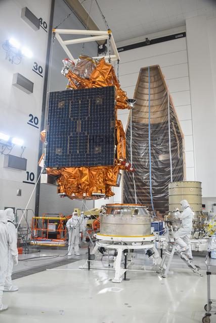 JPSS-2 spacecraft being carefully mated to its adapter in a clean room environment.