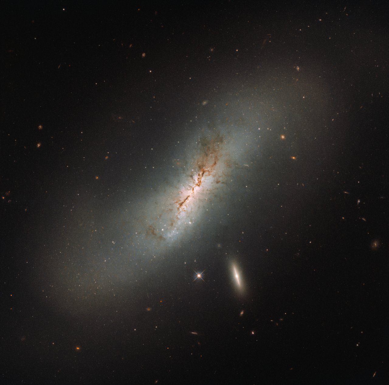 Hubble Space Telescope observes two galaxies interacting, showcasing their spiral arms and bright cores.