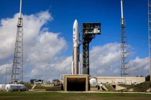 GOES-T satellite being transported to launch pad SLC-41 under clear blue skies.