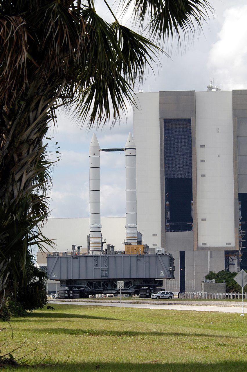 Mobile Launcher Platform with solid rocket boosters moving from Vehicle Assembly Building for vibration testing.