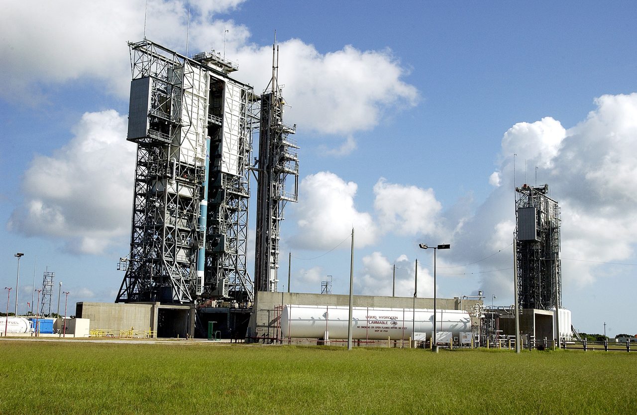 Delta II rocket's first stage being lifted at Kennedy Space Center's Launch Complex 17-B for SIRTF mission.