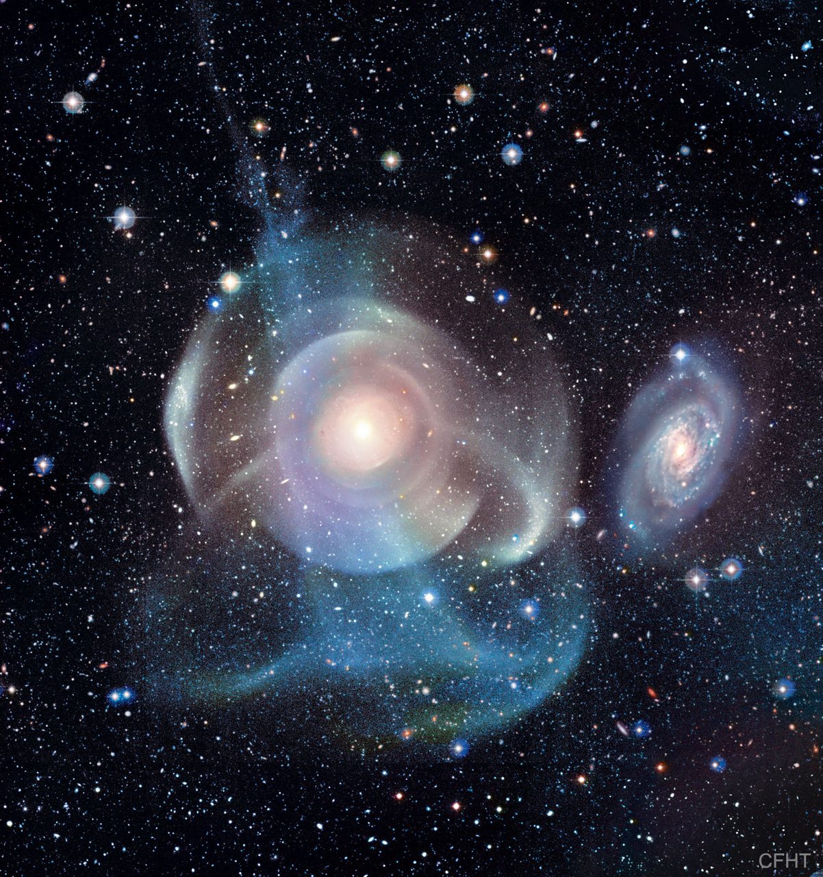 A detailed view of Galaxy NGC 474 showcasing its intricate shells and star streams against a dark cosmic background.
